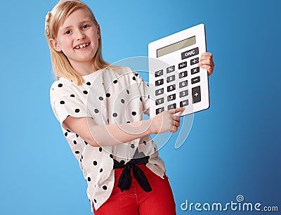 Happy modern child Ñlicking on button on calculator on blue Stock Photo